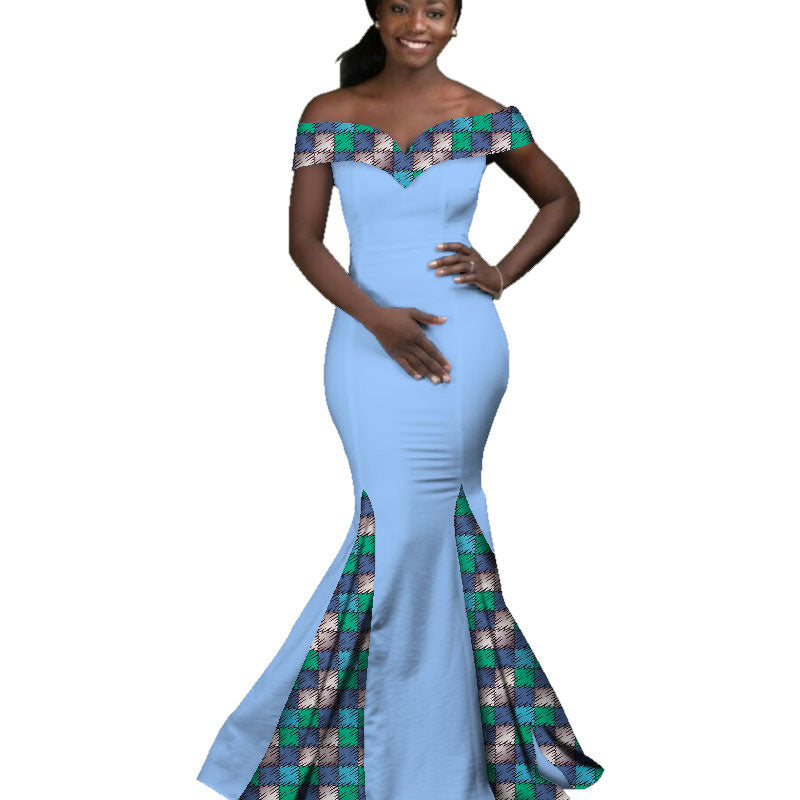 Woman wearing a blue dress with plaid accents on a white background