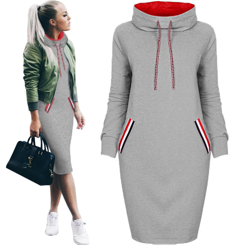 Gray dress with red lining and striped pockets worn by a model on a white background