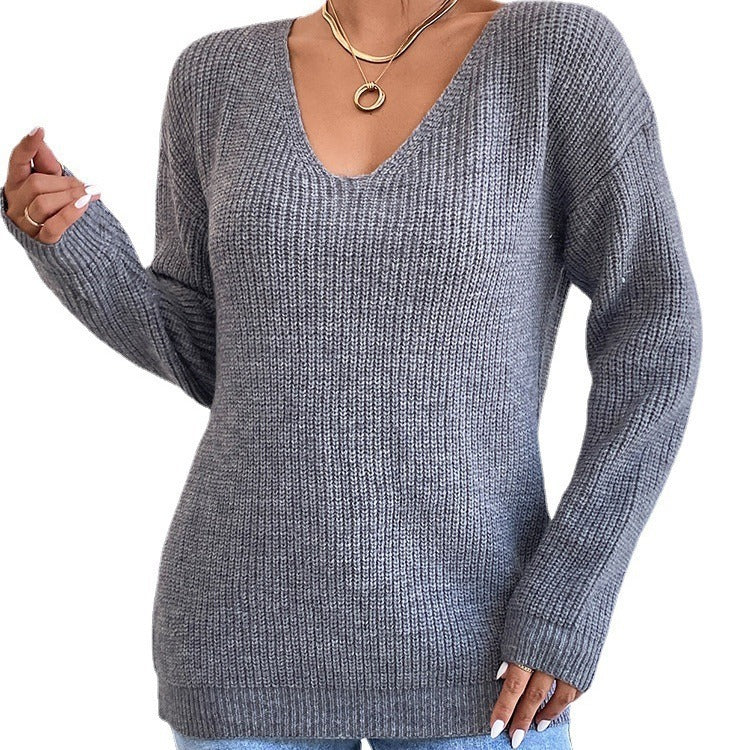 Gray ribbed sweater worn by a person on a white background
