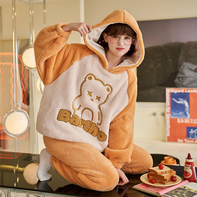 Person wearing a brown and white onesie with a bear design and 'Barbie' text.
