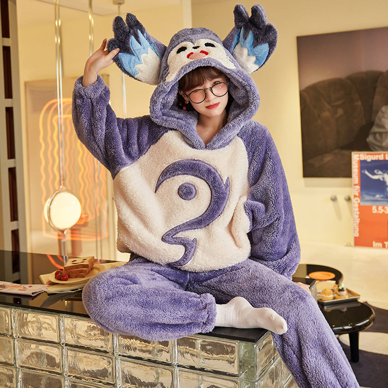 Person wearing a purple and white cartoon-themed onesie in a living room.