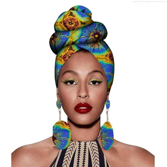 Woman wearing a colorful headscarf and earrings on a white background