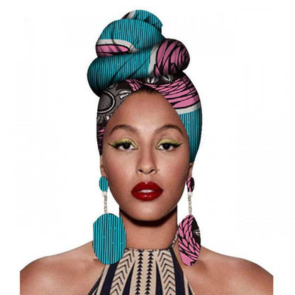 Woman wearing a colorful headscarf and earrings on a white background