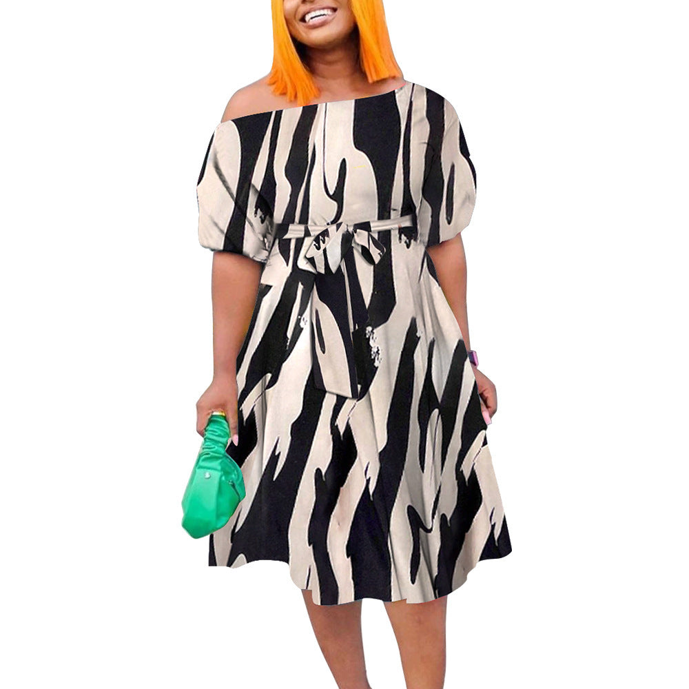 Woman wearing a black and white patterned dress on a white background