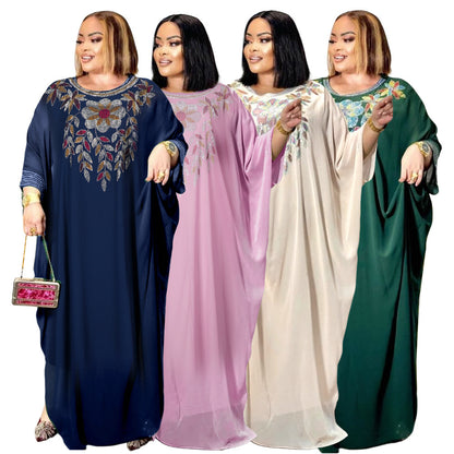 Four women wearing long, embroidered dresses in blue, pink, white, and green on a white background.