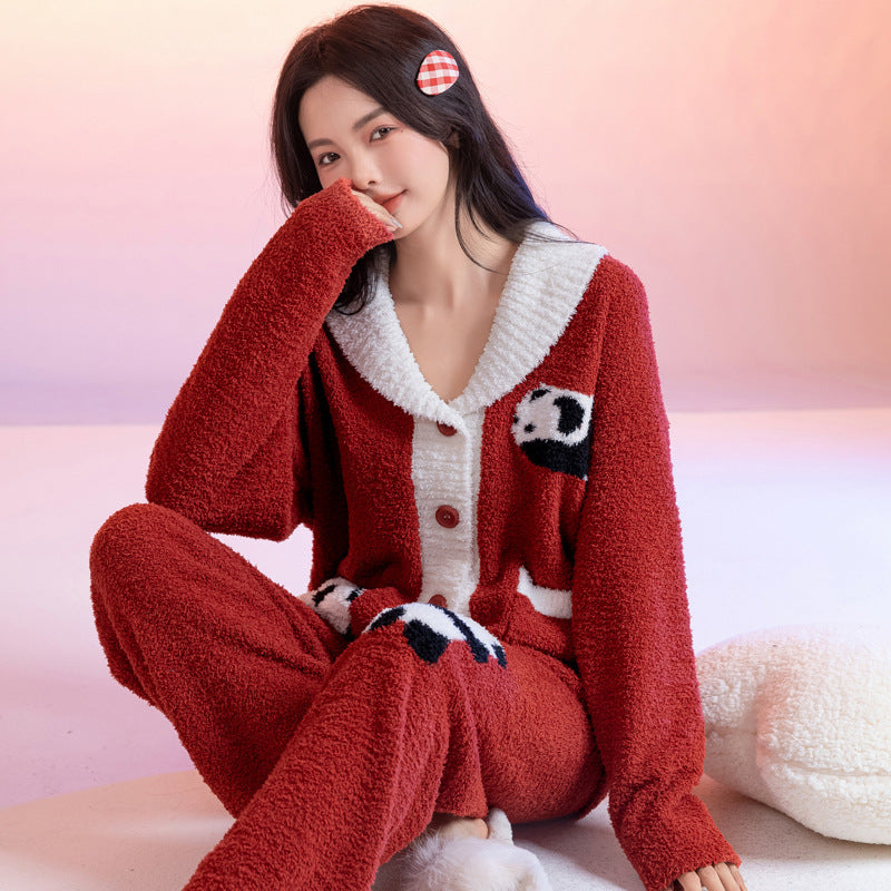 Person wearing a red and white fluffy pajama set sitting on a pink surface.