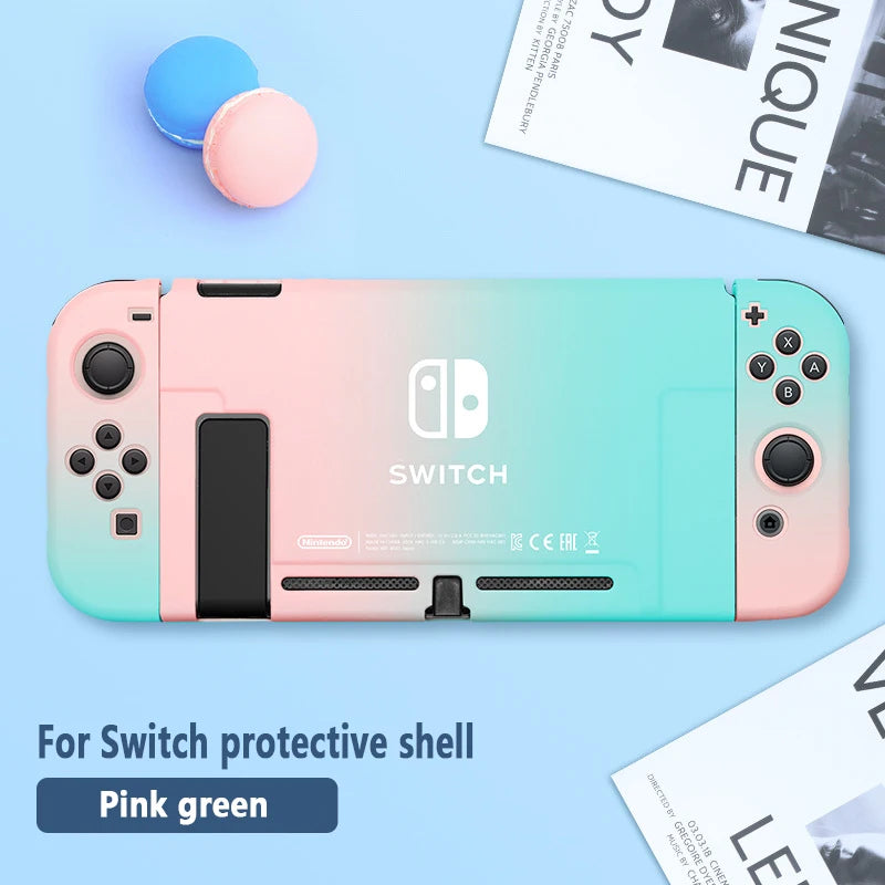 Pink and green Nintendo Switch protective shell on a blue surface with text and objects around.