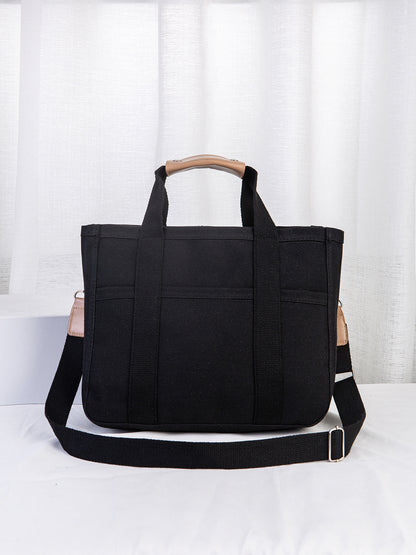 Black tote bag with a wooden handle on a white background