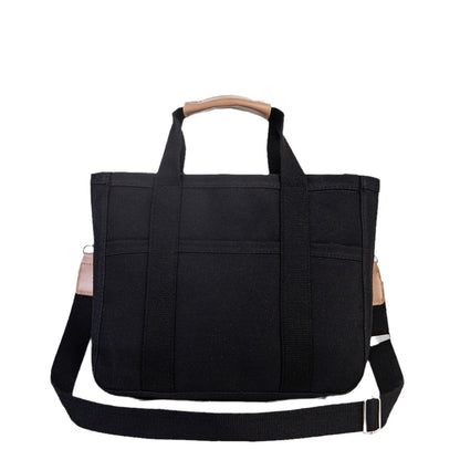 Black tote bag with a wooden handle on a white background