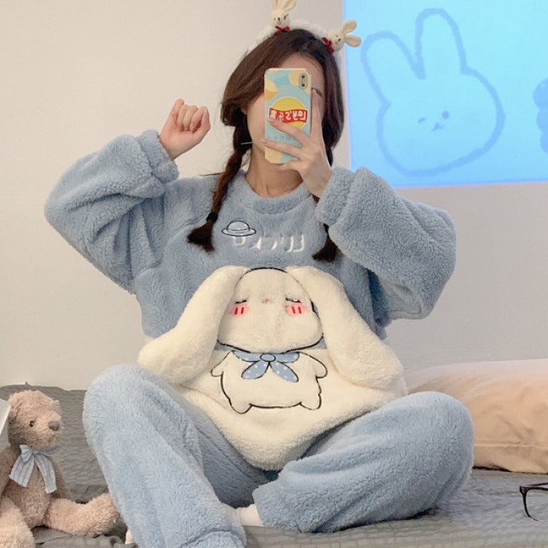 Person wearing a blue fleece outfit with cartoon design, sitting on a couch.