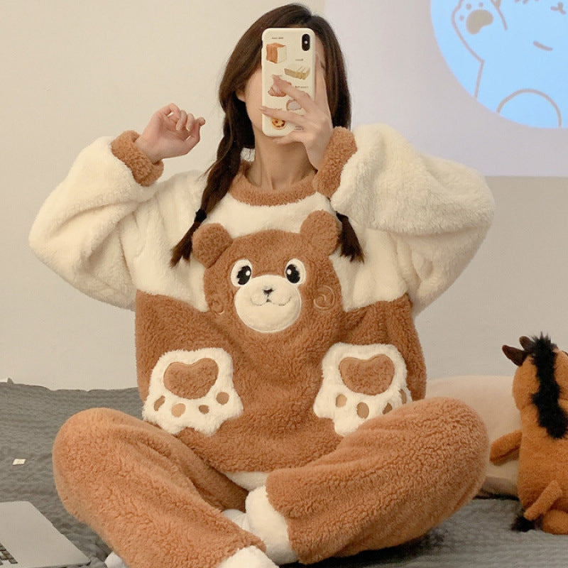 Person wearing a brown and white bear-themed pajama set sitting on a couch.