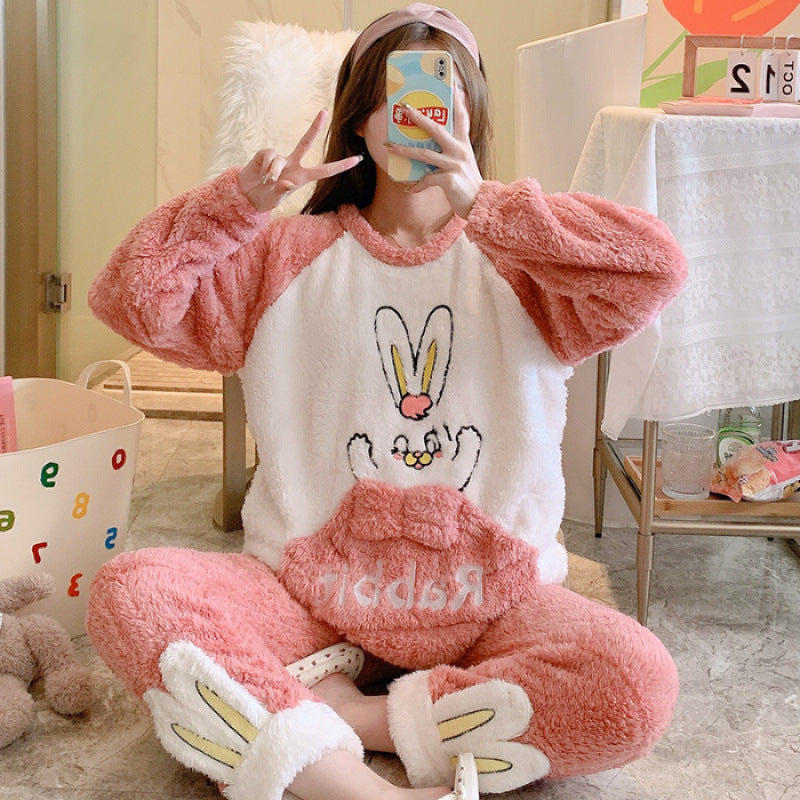 Person wearing a pink and white bunny-themed pajama set in a casual indoor setting.