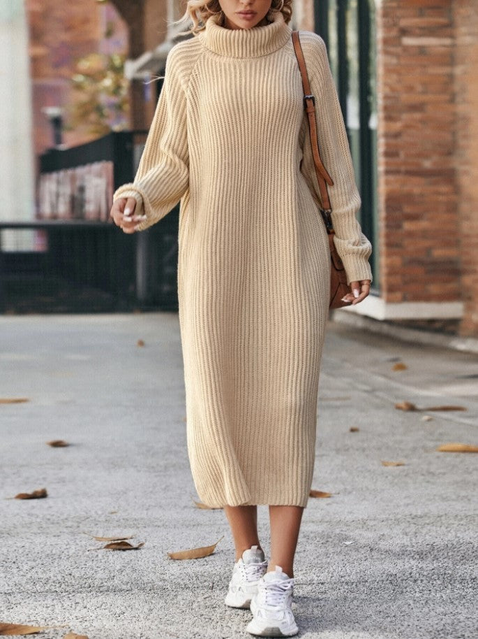 Person wearing a beige ribbed dress with white sneakers on a street.