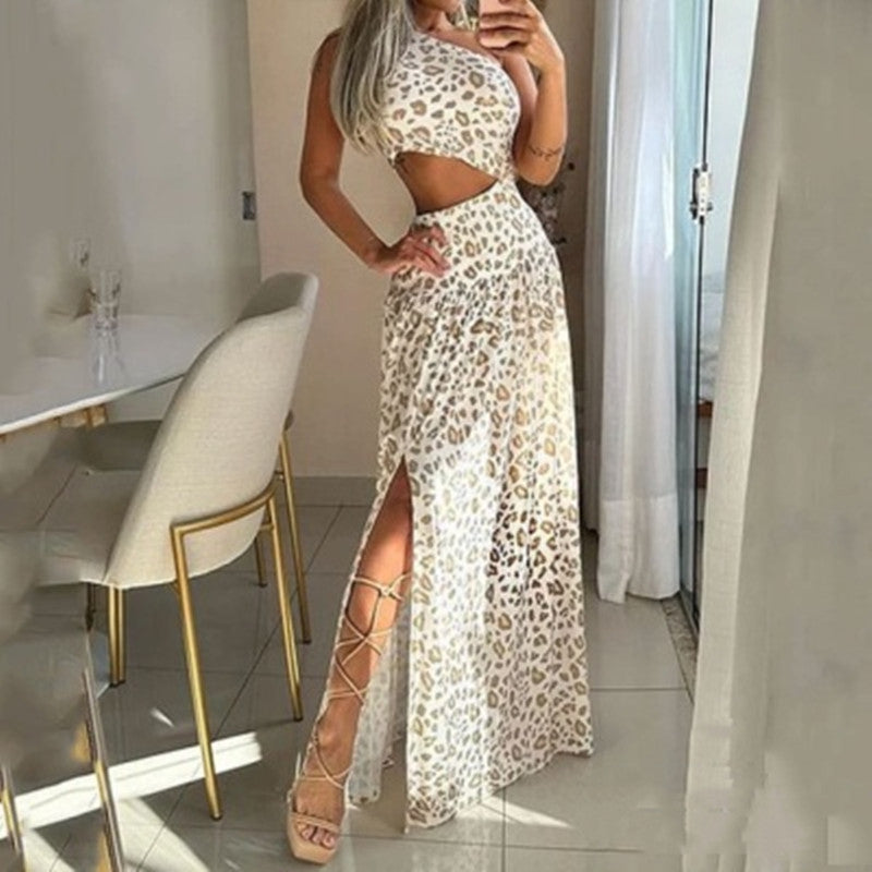Woman in a leopard print outfit standing in a modern interior setting.