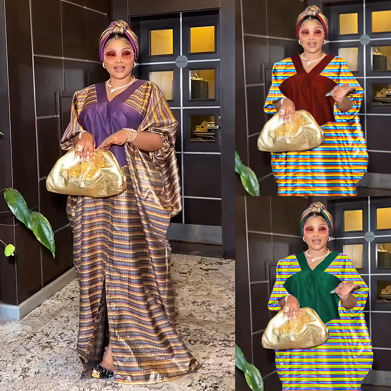 Woman in traditional attire holding a gold bag against a tiled wall.