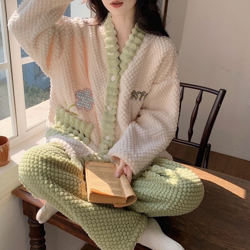 Person wearing a cozy, textured outfit with a floral design, sitting on a wooden chair.