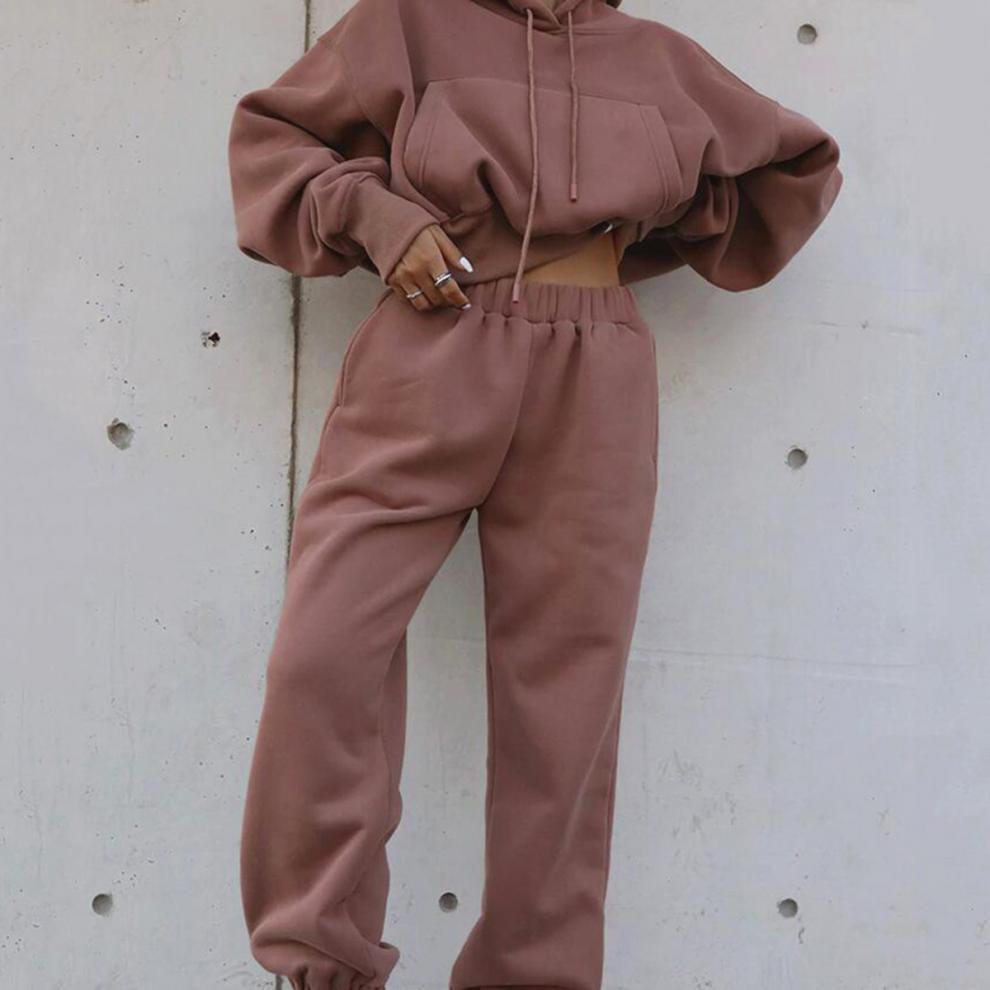 Brown hoodie and sweatpants set against a plain background