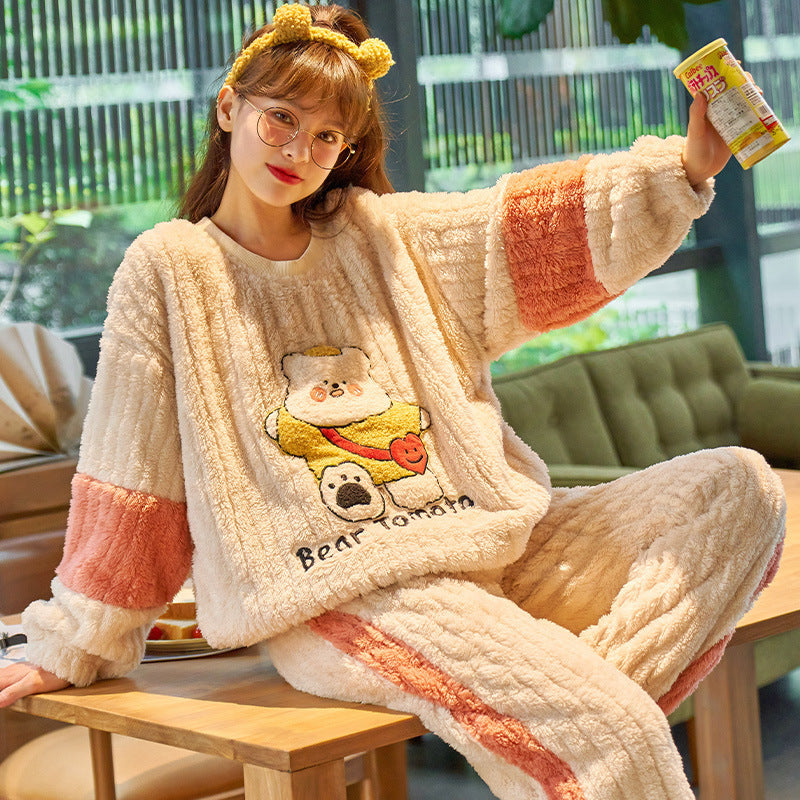 Person wearing a cozy, flannel pajama set with cartoon design in a casual setting.